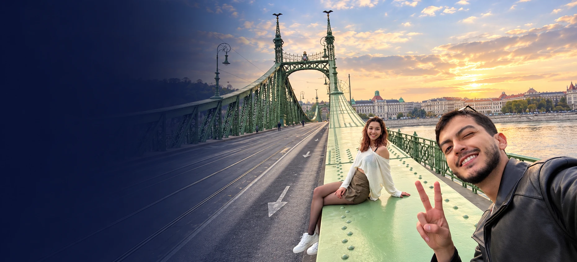 Two students on Liberty Bridge in Budapest at sunset